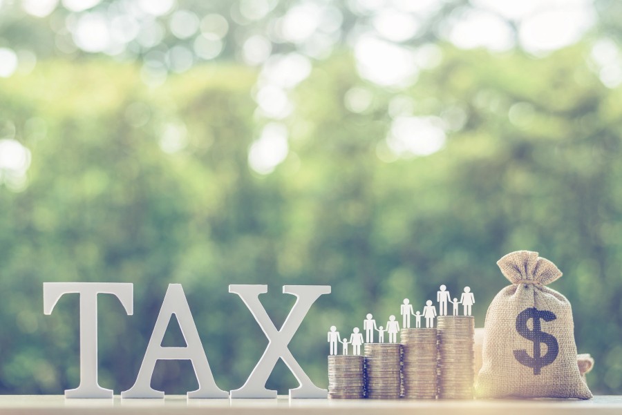 Tax and estate planning concept with coins and a money bag